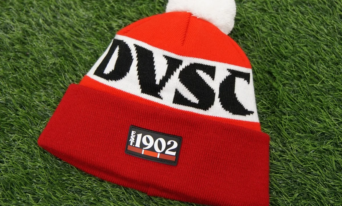 Red and white bobble hat with the letters DVSC and a 1902 patch